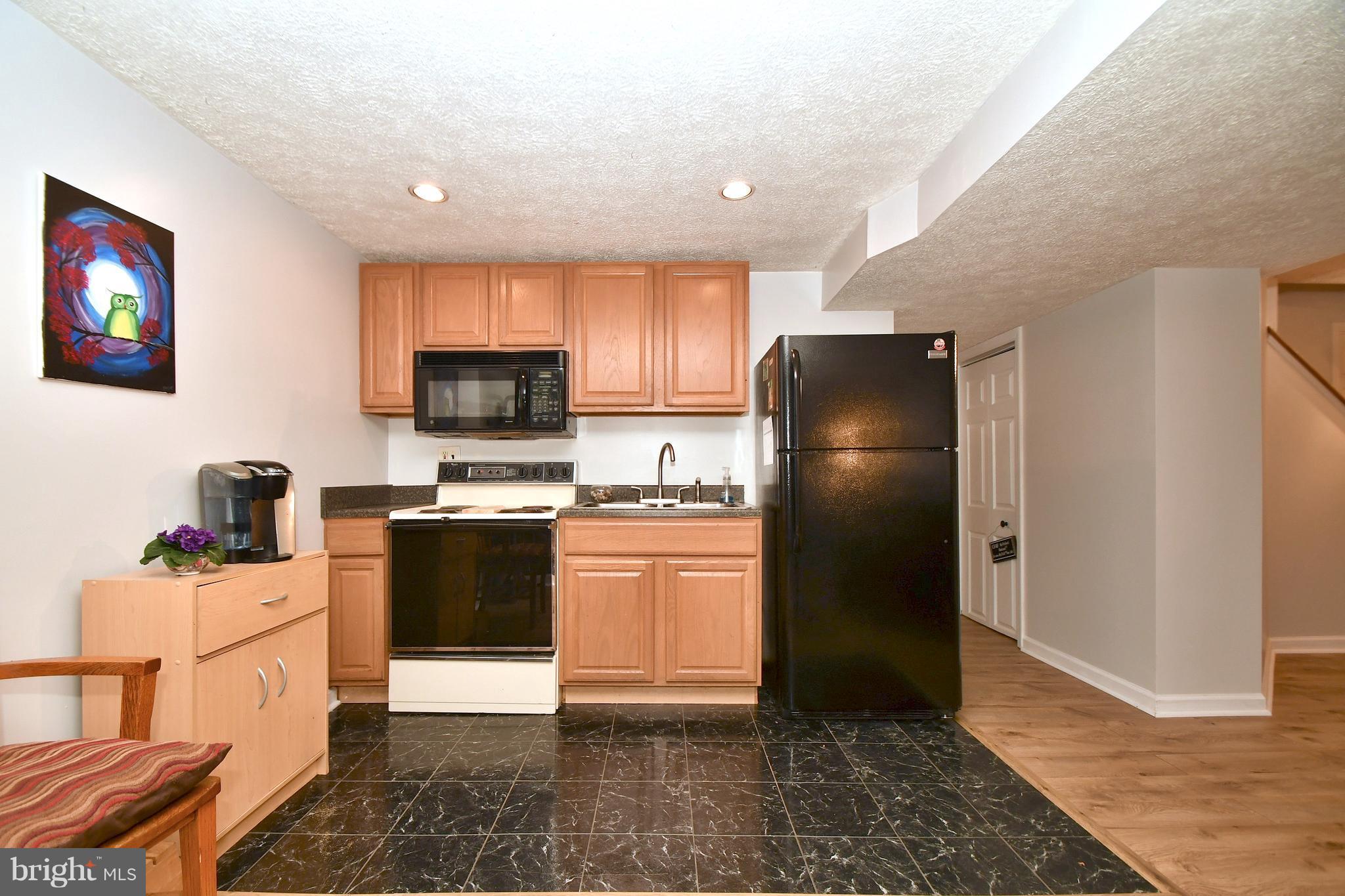 8126 Old Philadelphia Road Baltimore, MD 21237 - Photo 22 of 30 a kitchen with stainless steel appliances granite countertop a refrigerator stove top oven and sink