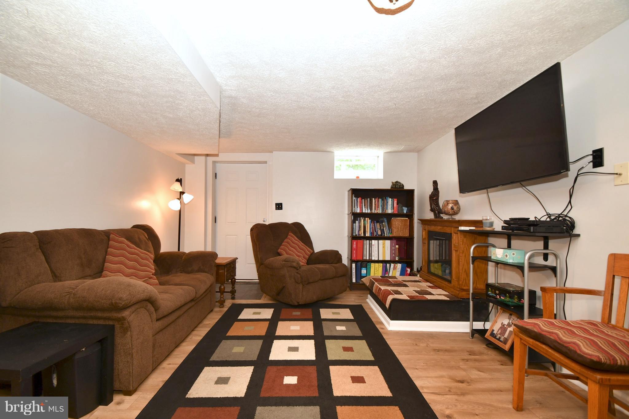 8126 Old Philadelphia Road Baltimore, MD 21237 - Photo 23 of 30 a living room with furniture and a flat screen tv