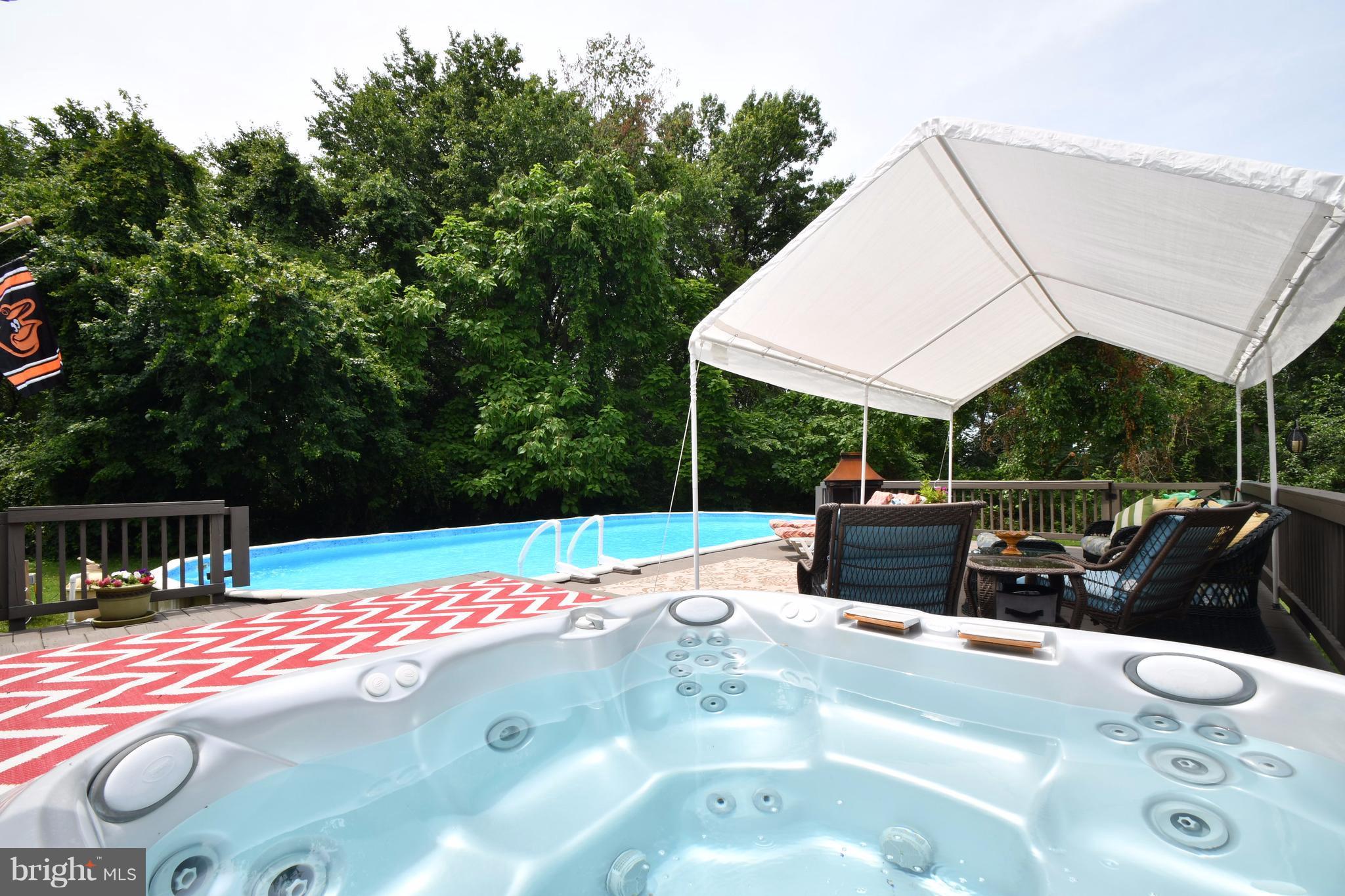 8126 Old Philadelphia Road Baltimore, MD 21237 - Photo 27 of 30 a view of a patio with couches table and chairs under an umbrella