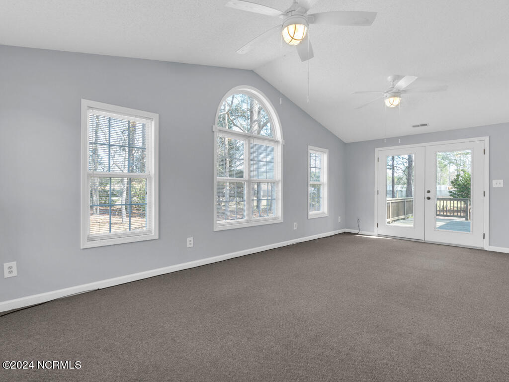 409 Deer Path Calabash, NC 28467 - Photo 21 of 32 The connection to the outdoors is further emphasized by the easy access to the open side deck, providing an extension of the living space and a perfect venue for outdoor relaxation, gatherings, or al fresco dining.