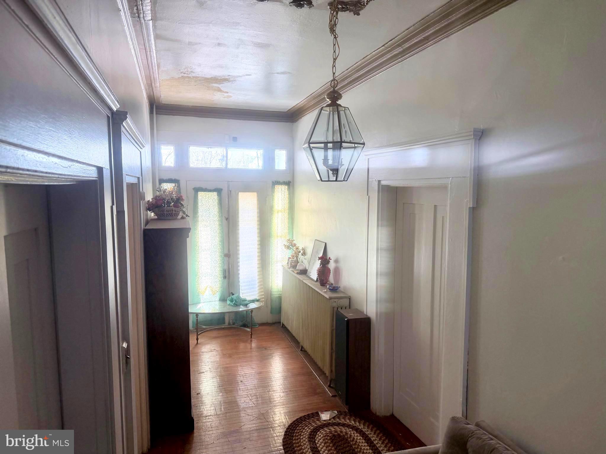 95 Mill Street Mount Holly, NJ 08060 - Photo 4 of 15 a view of a hallway with wooden floor and chandelier