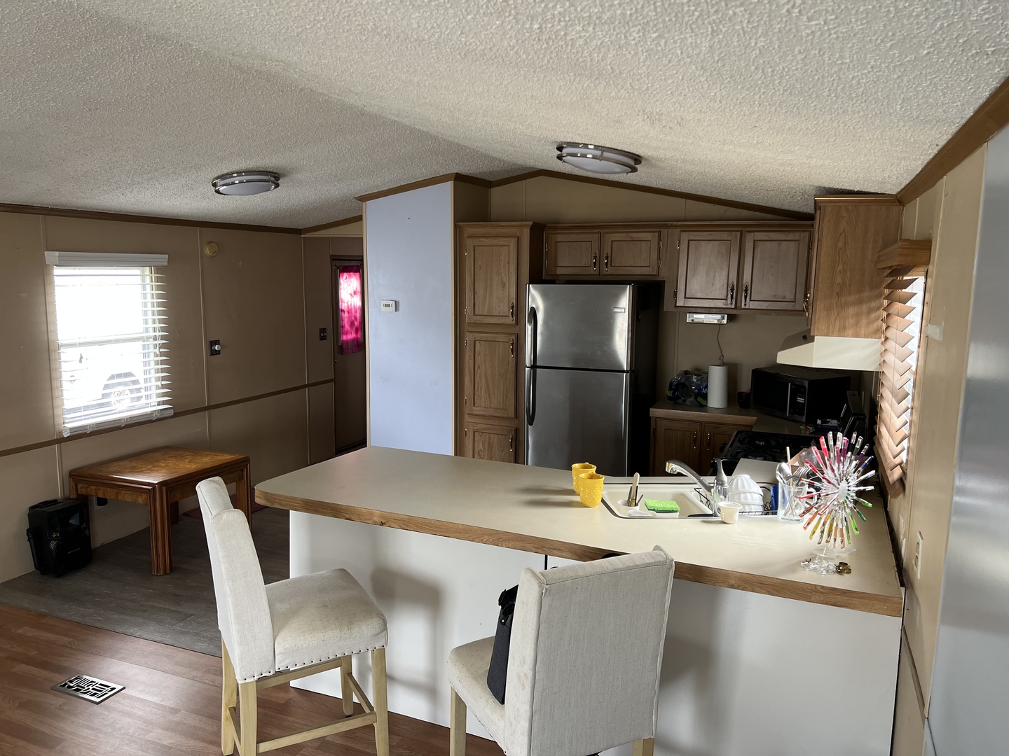 240 Whitney Road, Unit 21 Lake Zurich, IL 60047 - Photo 5 of 13 a kitchen with stainless steel appliances kitchen island granite countertop a refrigerator a microwave a sink and a stove