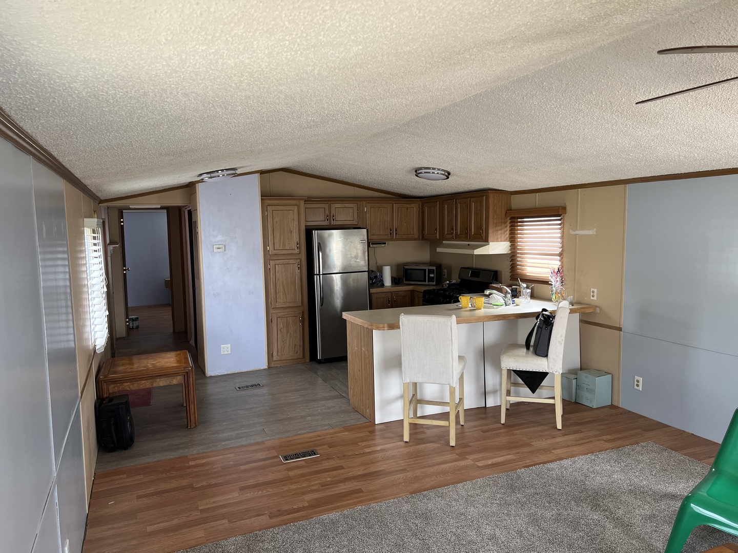 240 Whitney Road, Unit 21 Lake Zurich, IL 60047 - Photo 6 of 13 a kitchen with stainless steel appliances kitchen island granite countertop a refrigerator and a stove top oven