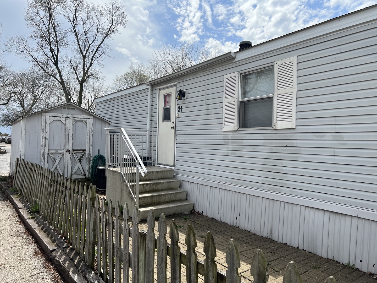 240 Whitney Road, Unit 21 Lake Zurich, IL 60047 - Photo 9 of 13 a view of a house with wooden fence