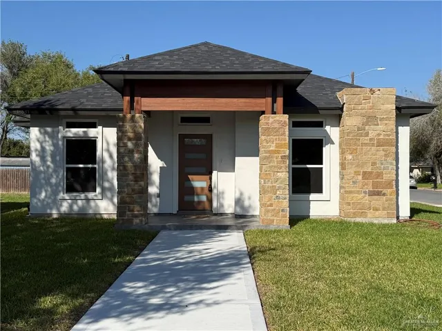 a view of a brick house with a large window