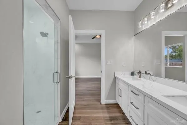 a view of a hallway with closet and a bathroom