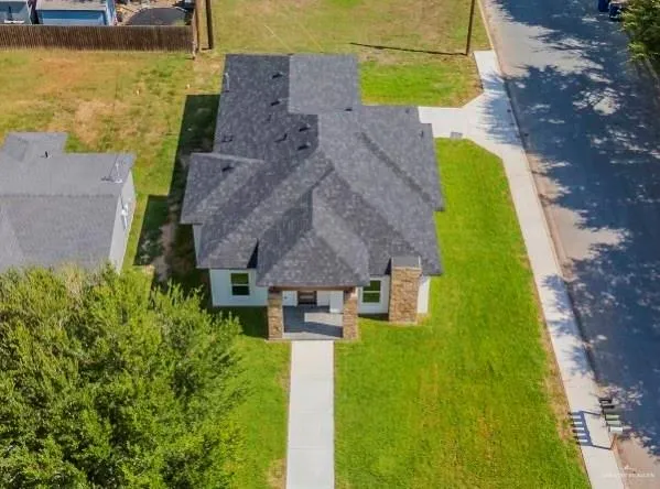 an aerial view of a house with a yard