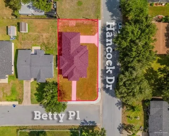 an aerial view of a house with a swimming pool
