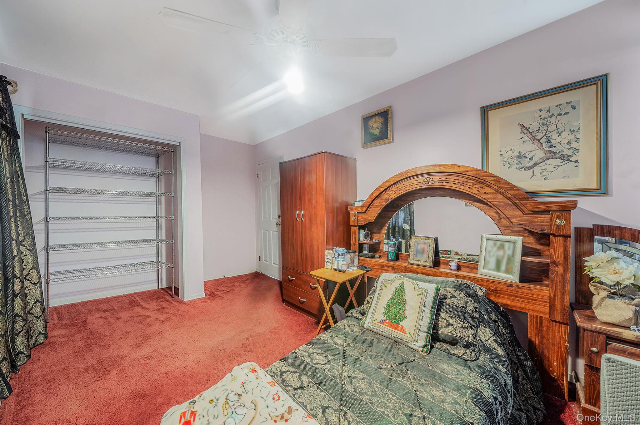 1169 Little E Neck Road West Babylon, NY 11704 - Photo 13 of 28 a bedroom with a bed and a painting on the wall