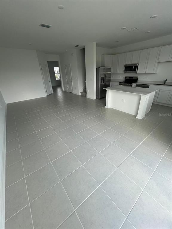 2660 Skyline Loop Kissimmee, FL 34758 - Photo 6 of 19 a view of a livingroom with kitchen furniture and electronic appliances