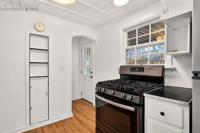 a kitchen with wooden cabinets and a stove top oven
