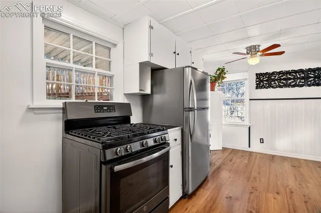 a kitchen with stainless steel appliances a stove a refrigerator and a cabinets