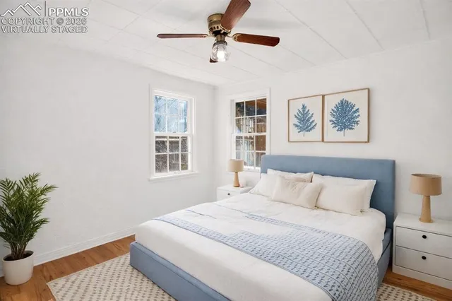 a bedroom with a bed and a painting on the wall