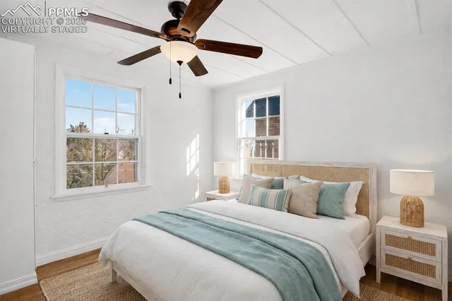 a bedroom with a large bed and a window