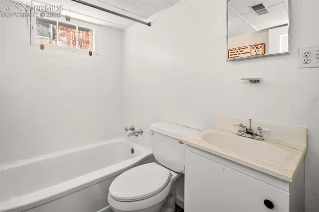 a white toilet sitting next to a bath tub
