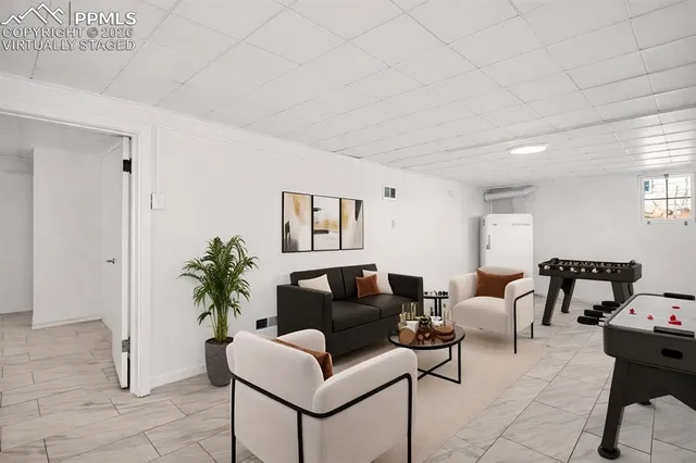 a living room with furniture and a potted plant