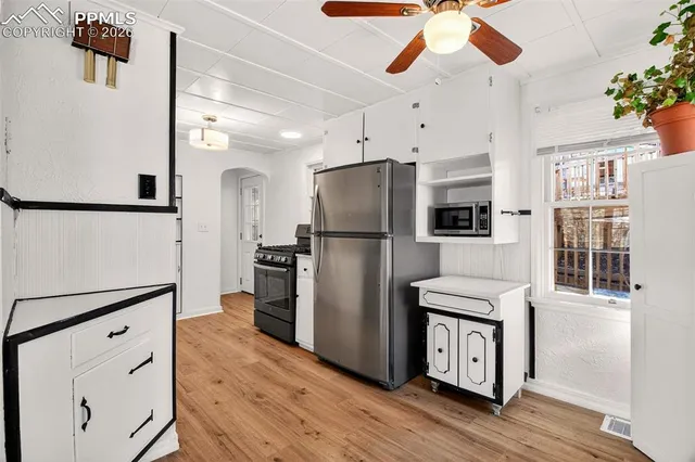 a kitchen with stainless steel appliances a refrigerator and a stove