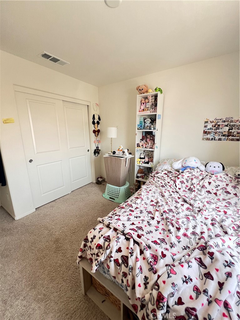 31381 Linden Flower Road Winchester, CA 92596 - Photo 19 of 33 a bedroom with a bed and closet