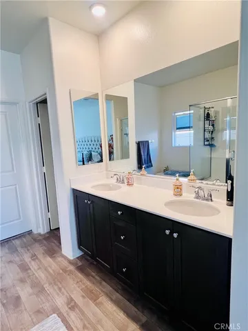 a bathroom with a double vanity sink and mirror