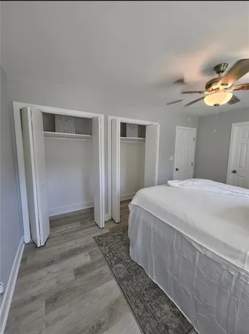 a spacious bedroom with a bed and a lamp