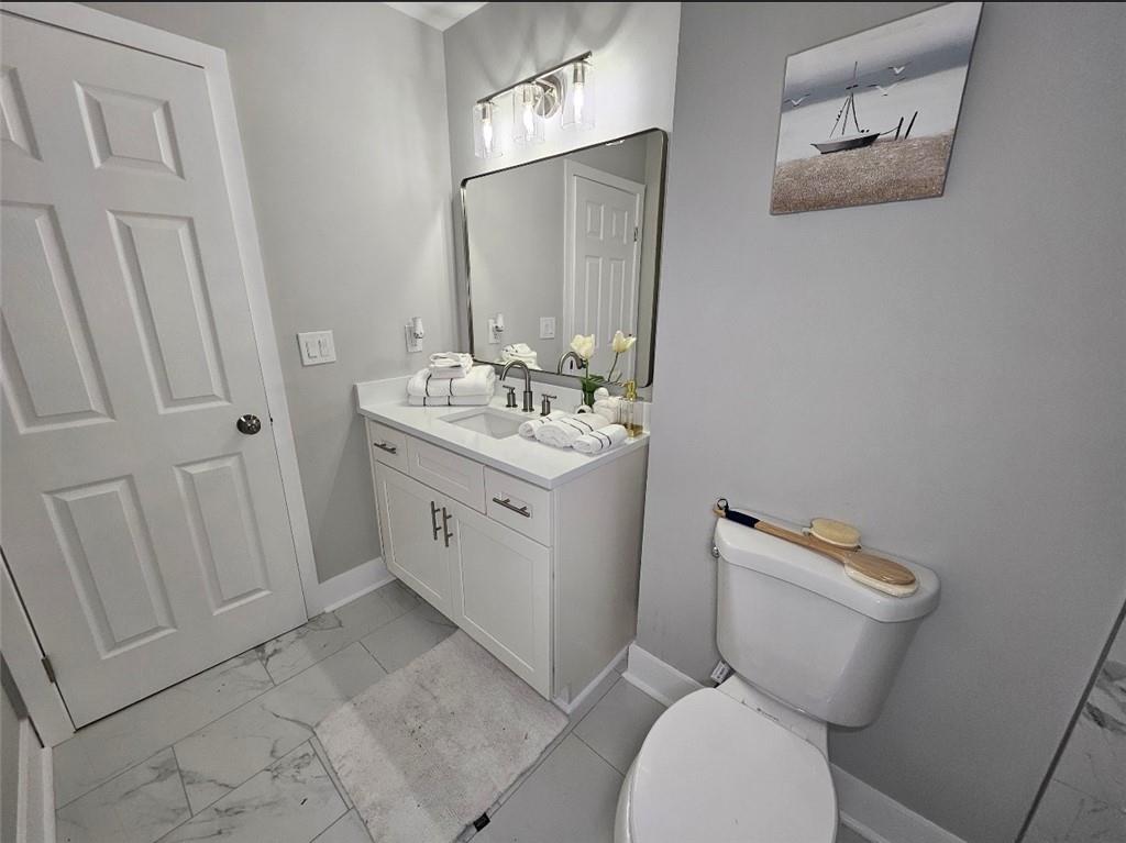 2968 McGlynn Court Decatur, GA 30034 - Photo 21 of 34 a bathroom with a toilet sink and mirror