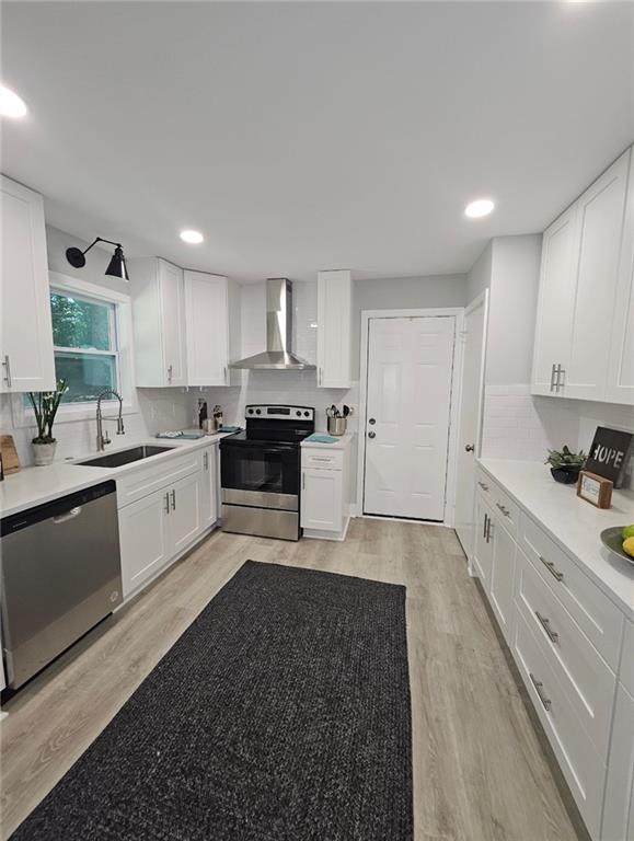 2968 McGlynn Court Decatur, GA 30034 - Photo 6 of 34 a large white kitchen with stainless steel appliances granite countertop a stove a sink a refrigerator and white cabinets with wooden floor