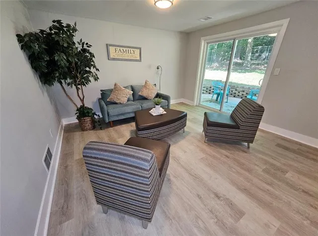 a living room with furniture and a potted plant