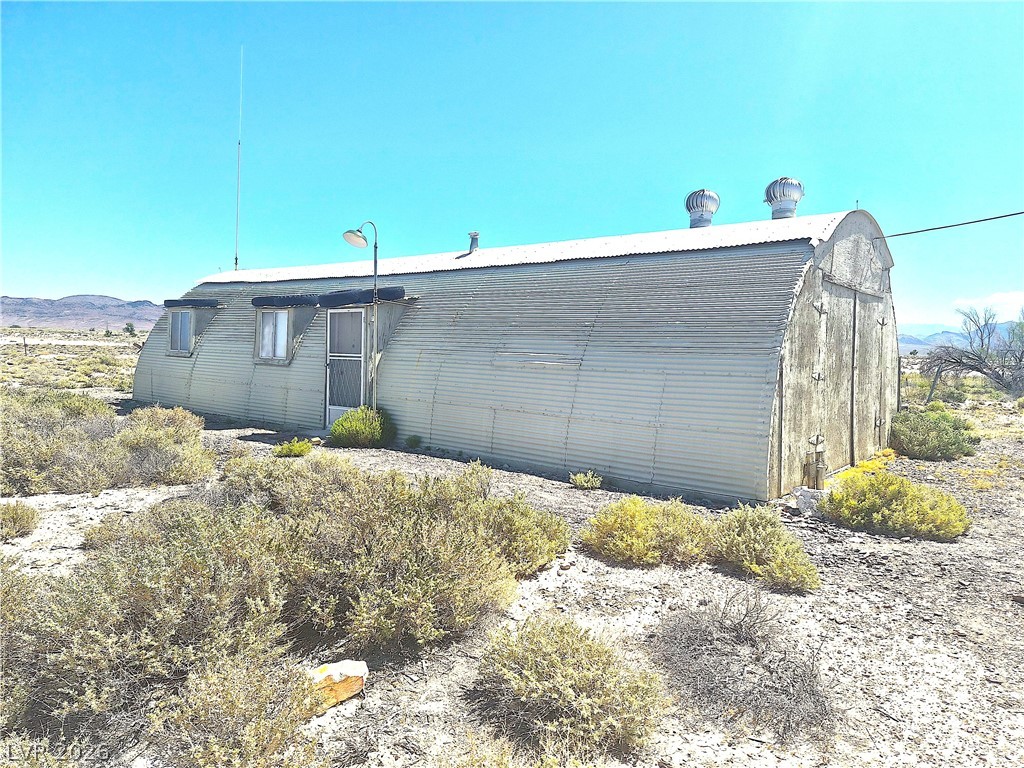 11545 South Spring Meadows Road Pahrump, NV 89060 - Photo 6 of 33 This unique structure offers a distinctive design amidst a natural desert landscape.