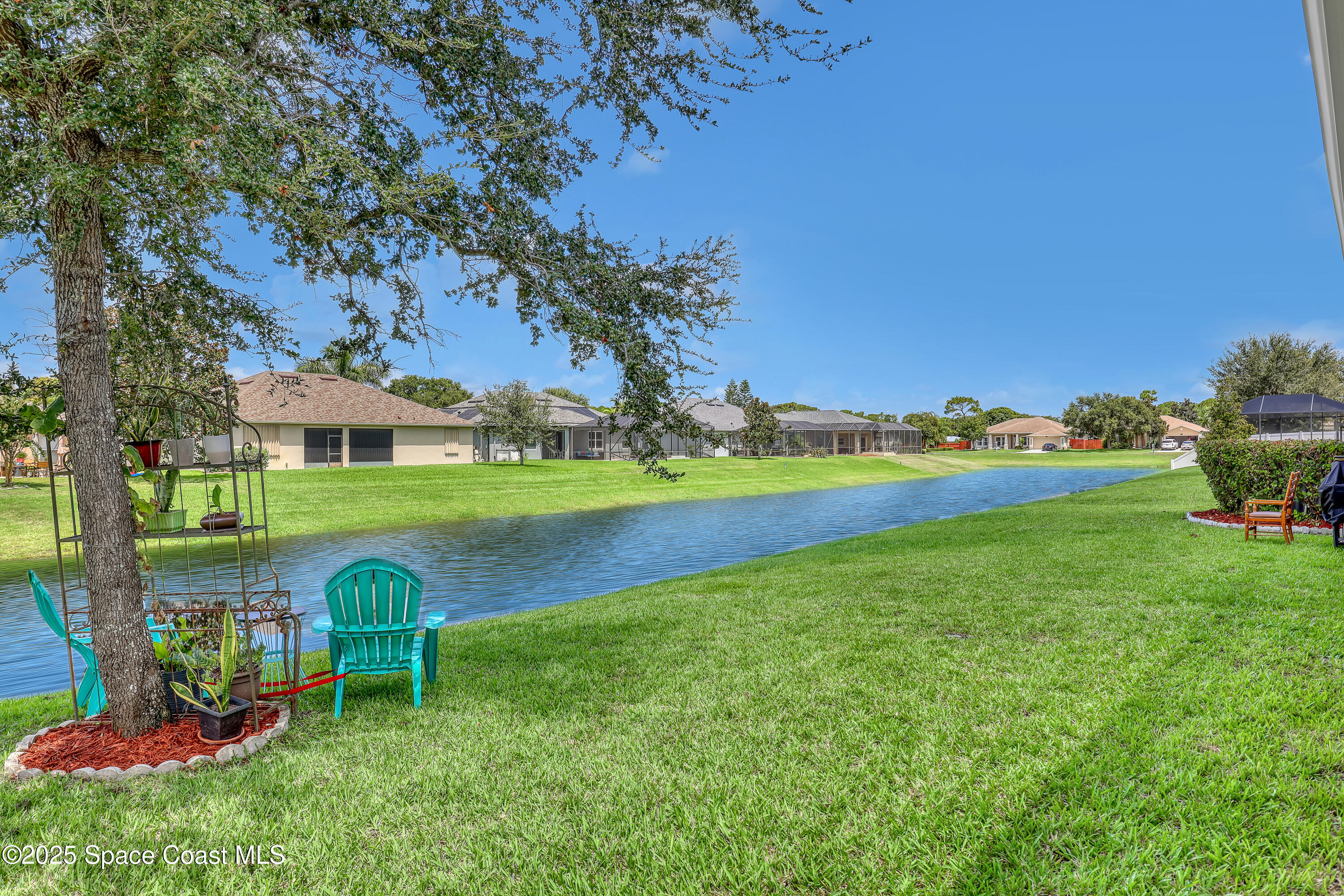 1121 Morgan Circle Northeast Palm Bay, FL 32905 - Photo 101 of 115 a view of a garden with a bench in the garden