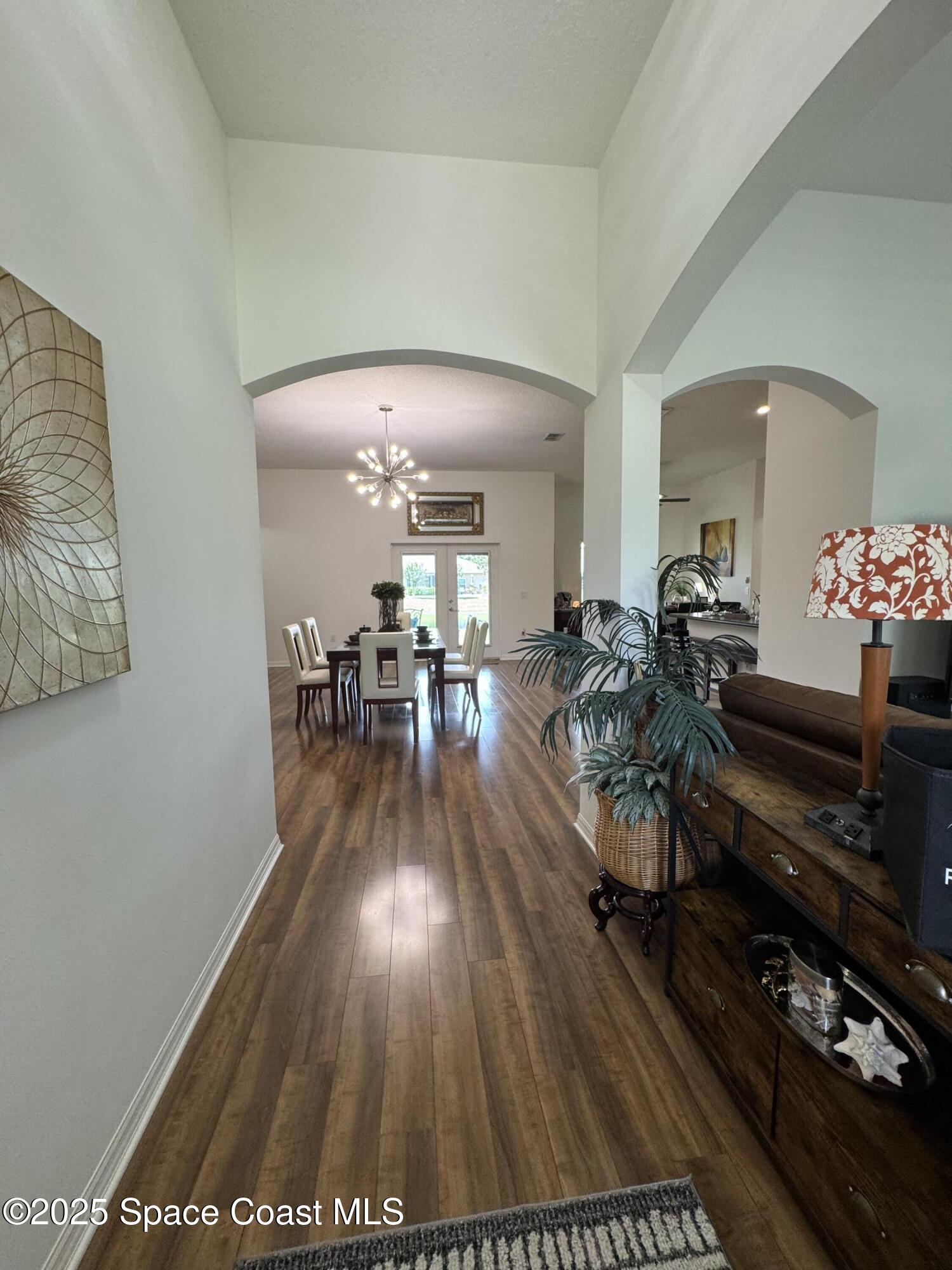 1121 Morgan Circle Northeast Palm Bay, FL 32905 - Photo 13 of 64 a hallway with wooden floor and furniture