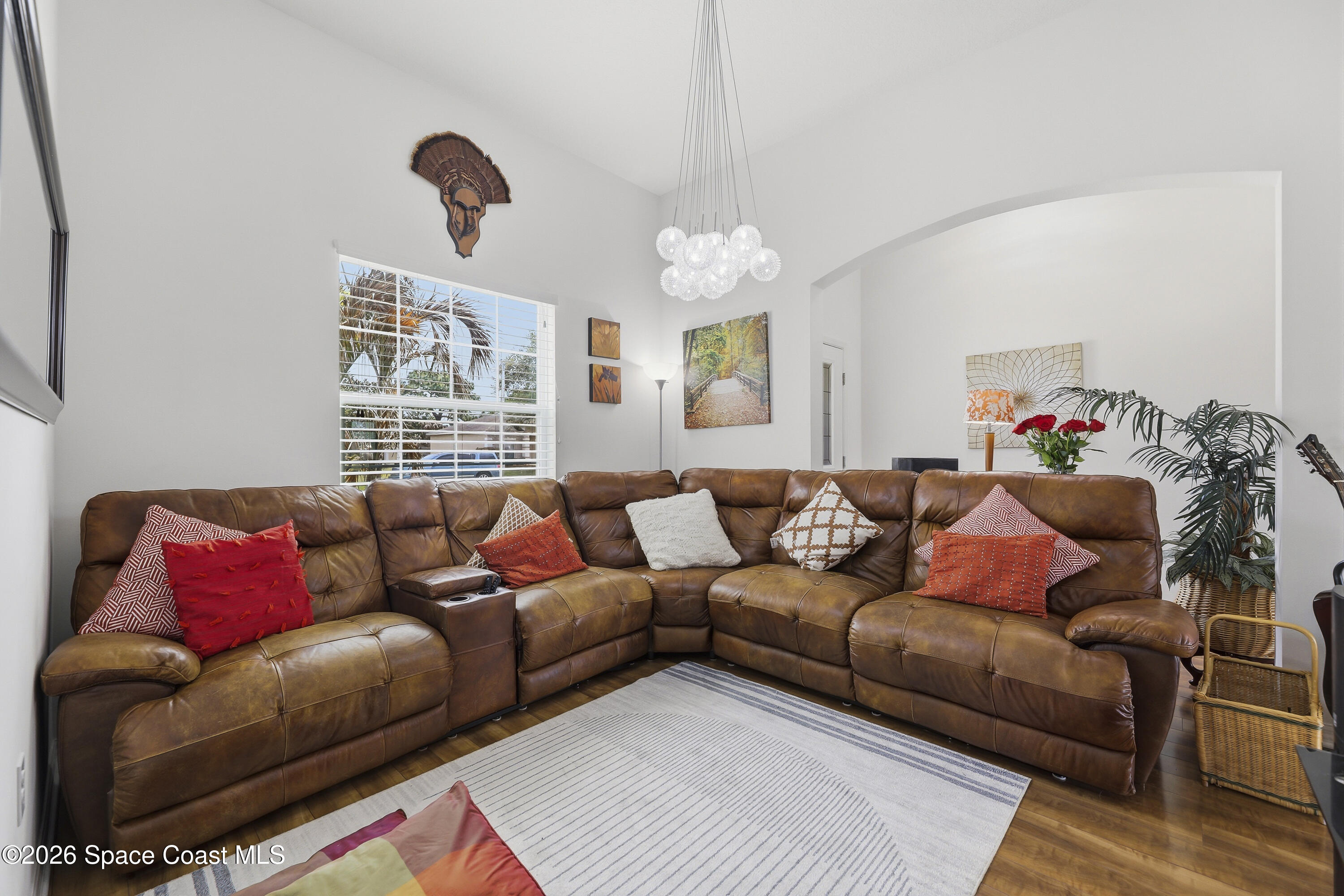 1121 Morgan Circle Northeast Palm Bay, FL 32905 - Photo 16 of 115 a living room with furniture a couch and chandelier