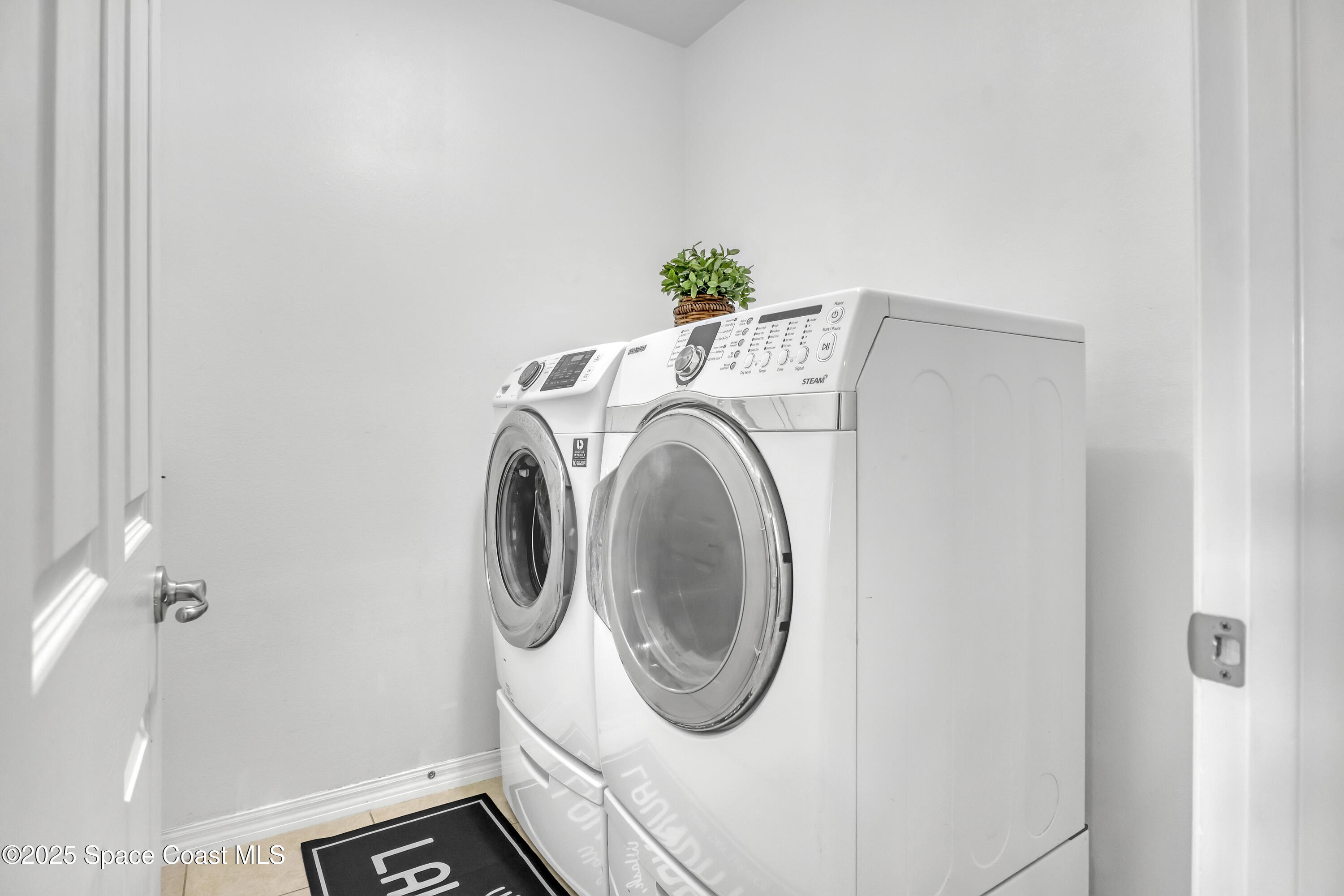 1121 Morgan Circle Northeast Palm Bay, FL 32905 - Photo 27 of 64 a utility room with dryer and washer