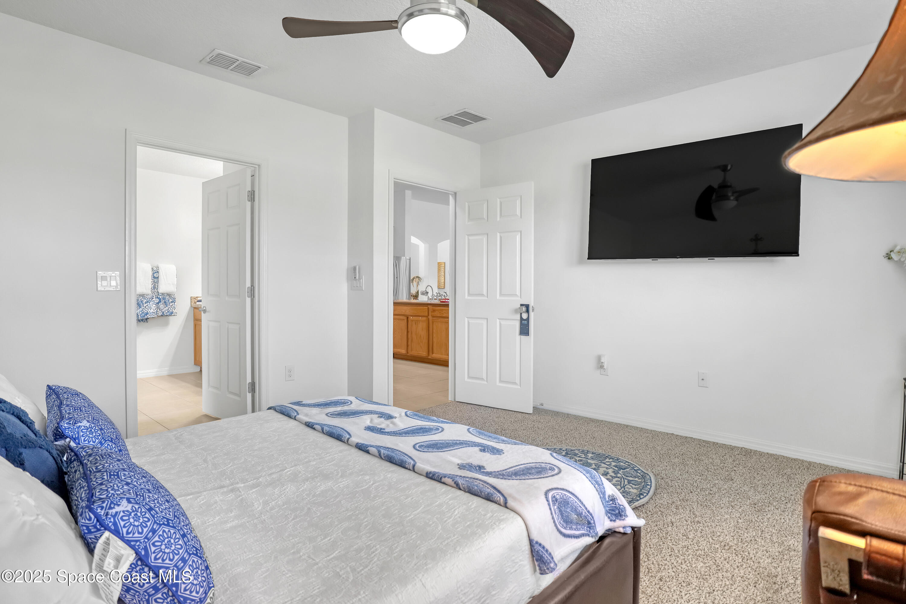 1121 Morgan Circle Northeast Palm Bay, FL 32905 - Photo 27 of 61 a bedroom with a bed and a television