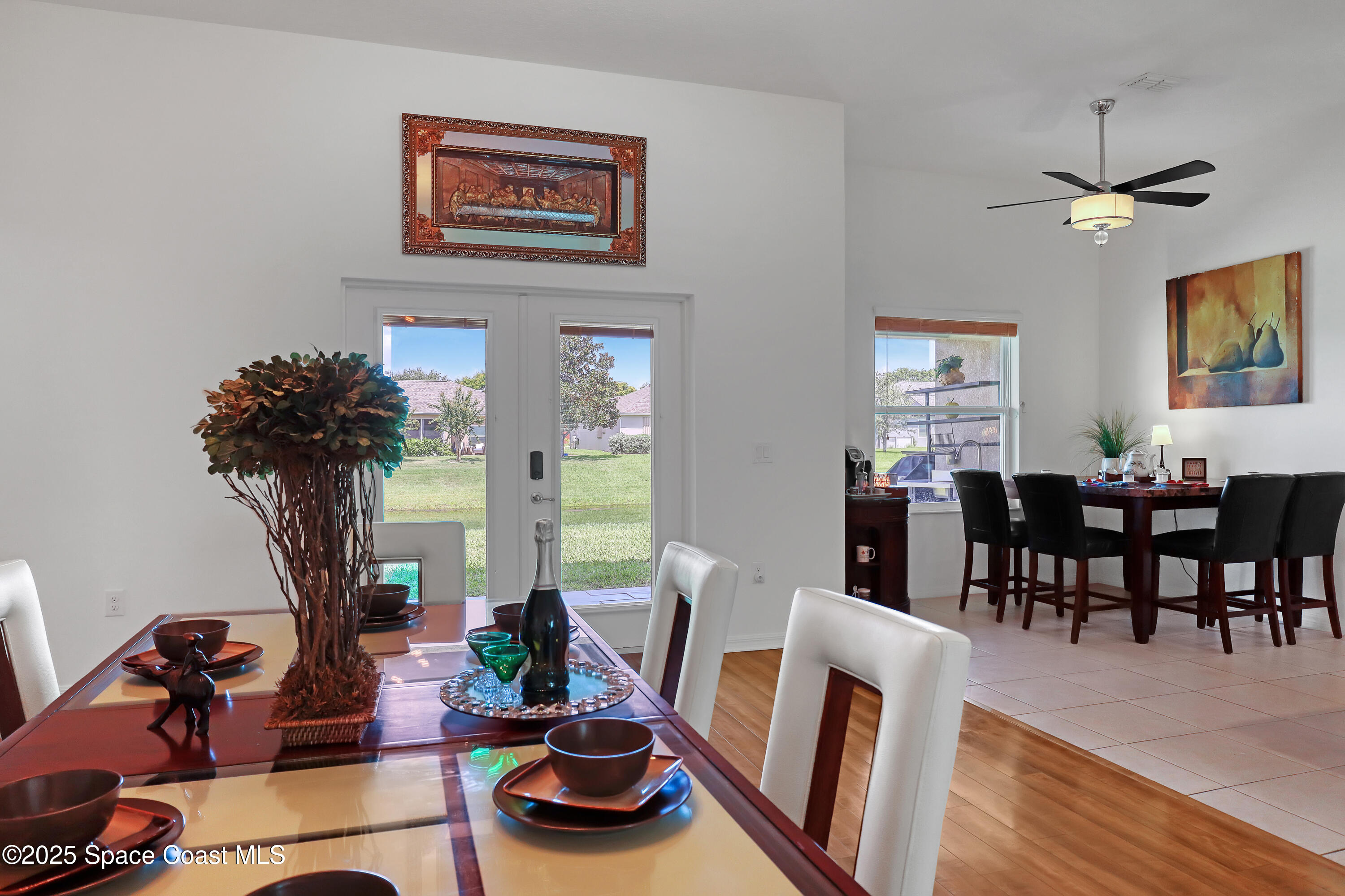 1121 Morgan Circle Northeast Palm Bay, FL 32905 - Photo 32 of 115 a living room with furniture a dining table and wooden floor