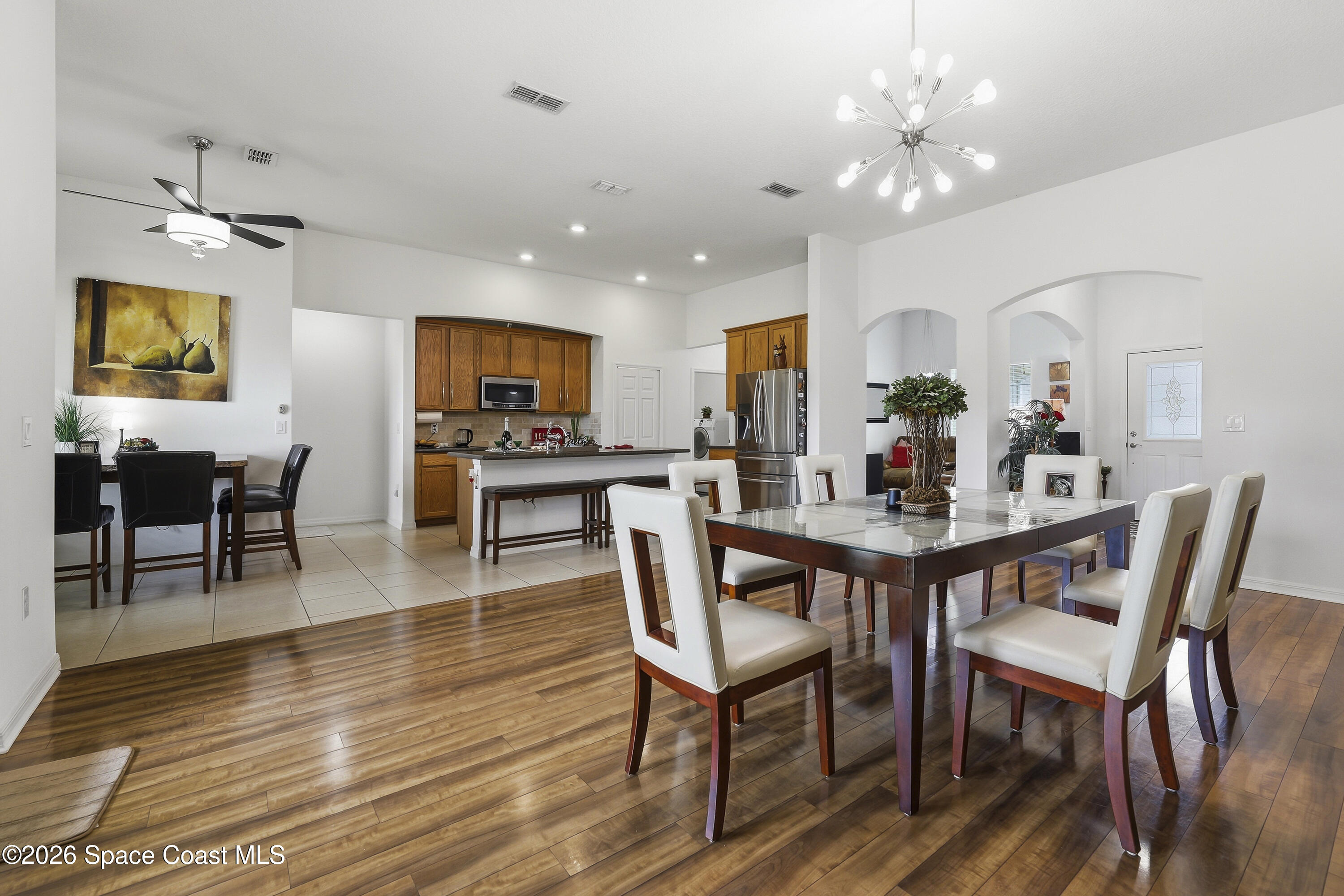 1121 Morgan Circle Northeast Palm Bay, FL 32905 - Photo 33 of 115 a view of a dining room with furniture and wooden floor