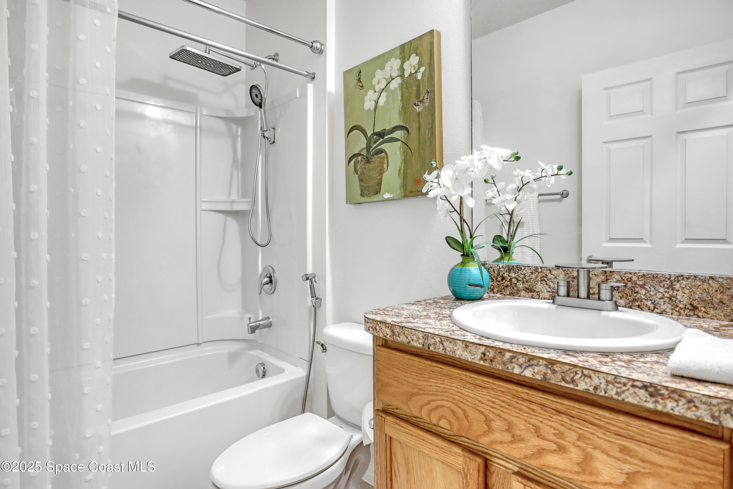 1121 Morgan Circle Northeast Palm Bay, FL 32905 - Photo 38 of 61 a bathroom with a granite countertop sink a toilet and shower