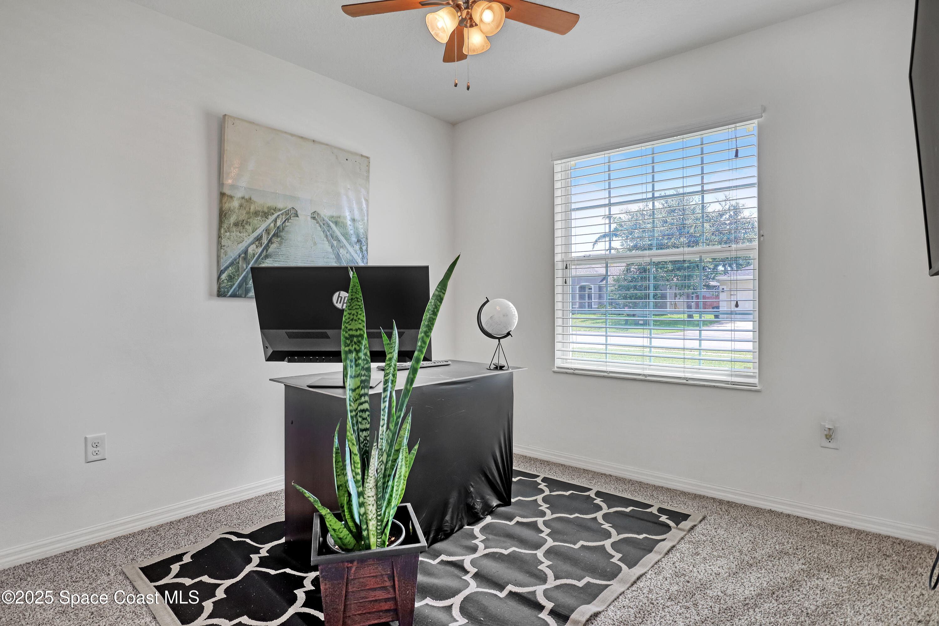 1121 Morgan Circle Northeast Palm Bay, FL 32905 - Photo 39 of 64 a living room with furniture and a flat screen tv