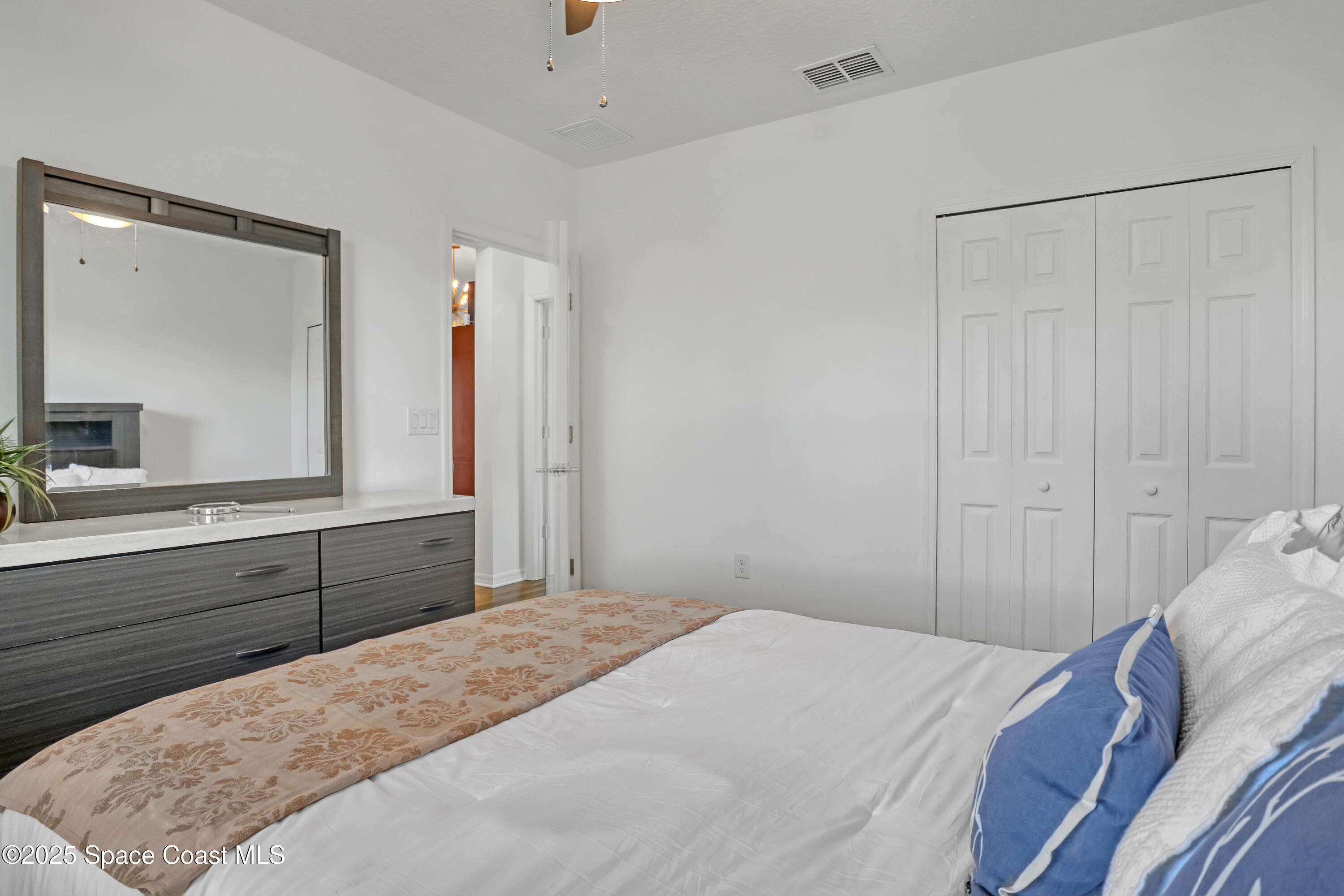 1121 Morgan Circle Northeast Palm Bay, FL 32905 - Photo 43 of 61 a bedroom with a bed and a dresser