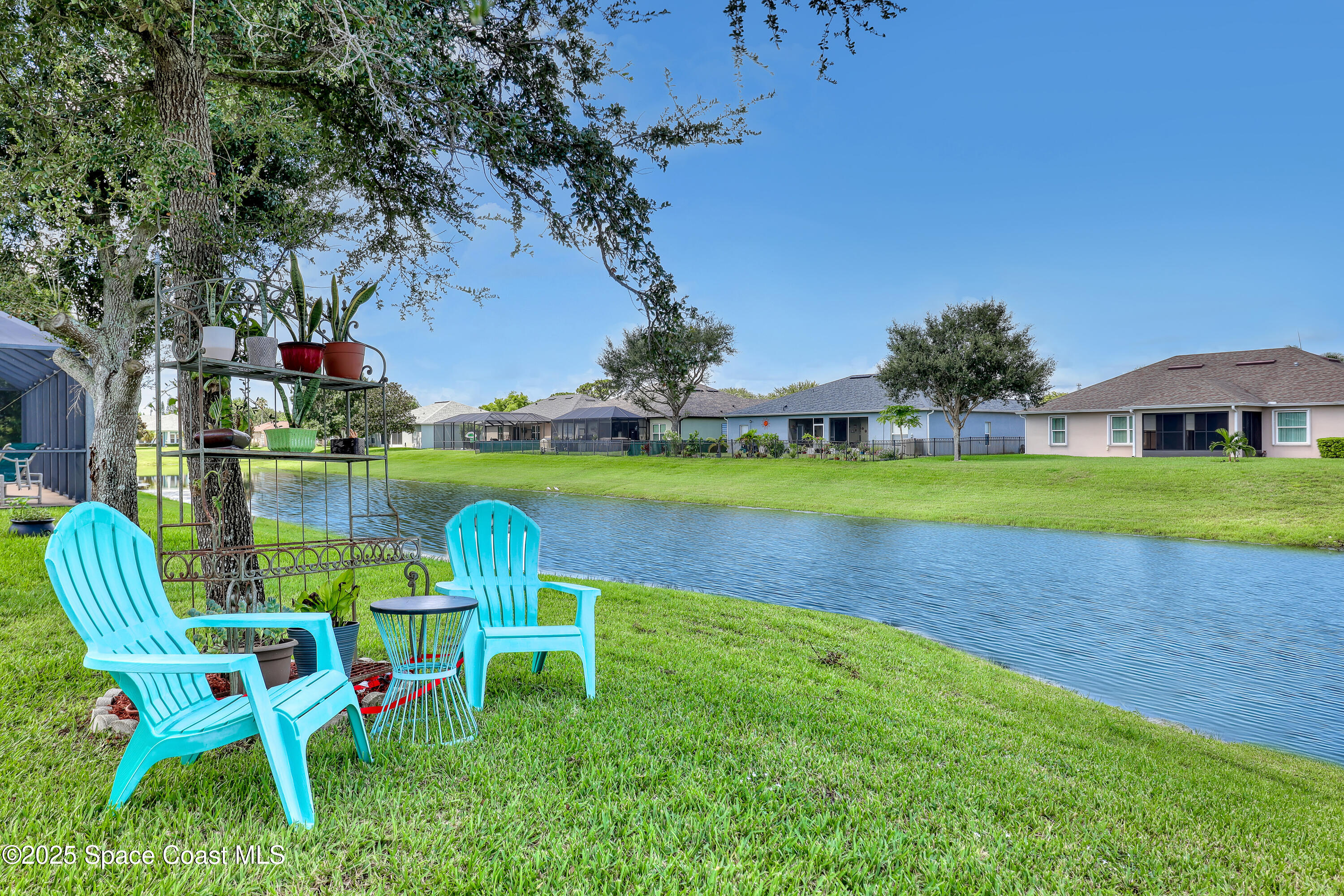 1121 Morgan Circle Northeast Palm Bay, FL 32905 - Photo 52 of 61 a view of a chair and table in the garden