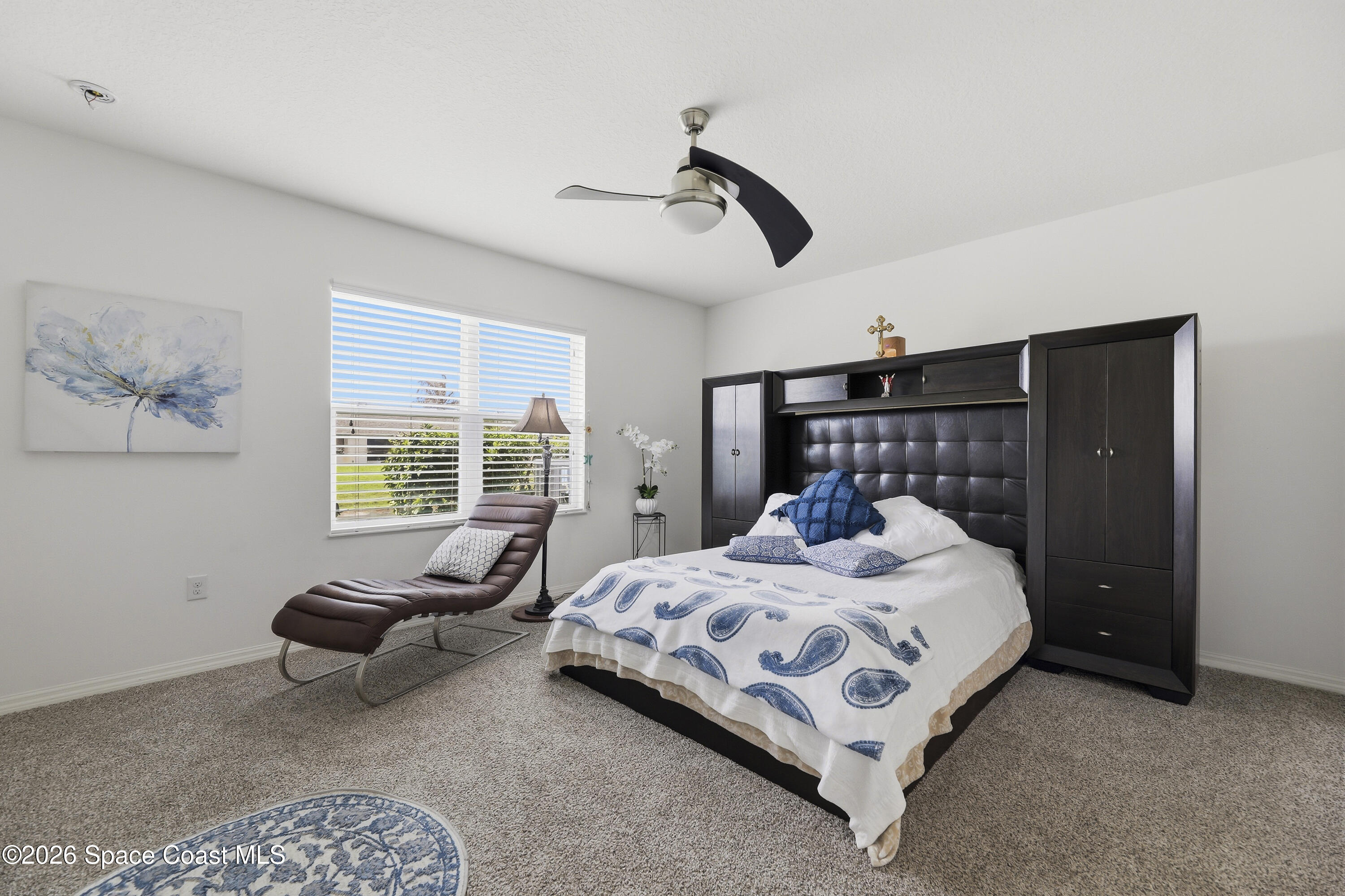 1121 Morgan Circle Northeast Palm Bay, FL 32905 - Photo 56 of 115 a bedroom with a bed couch and a large window