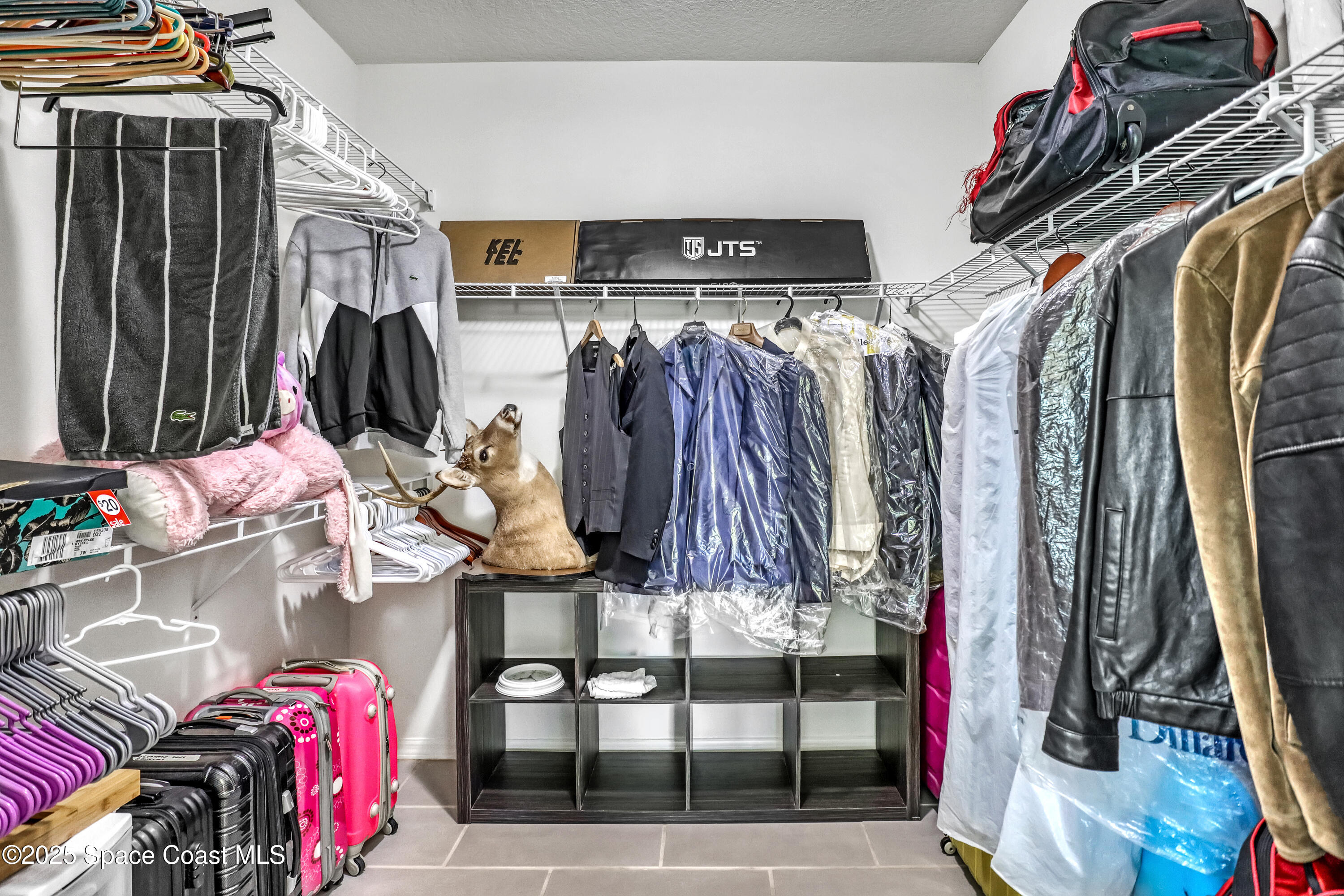 1121 Morgan Circle Northeast Palm Bay, FL 32905 - Photo 67 of 115 a view of walk in closet with clothes and shoes