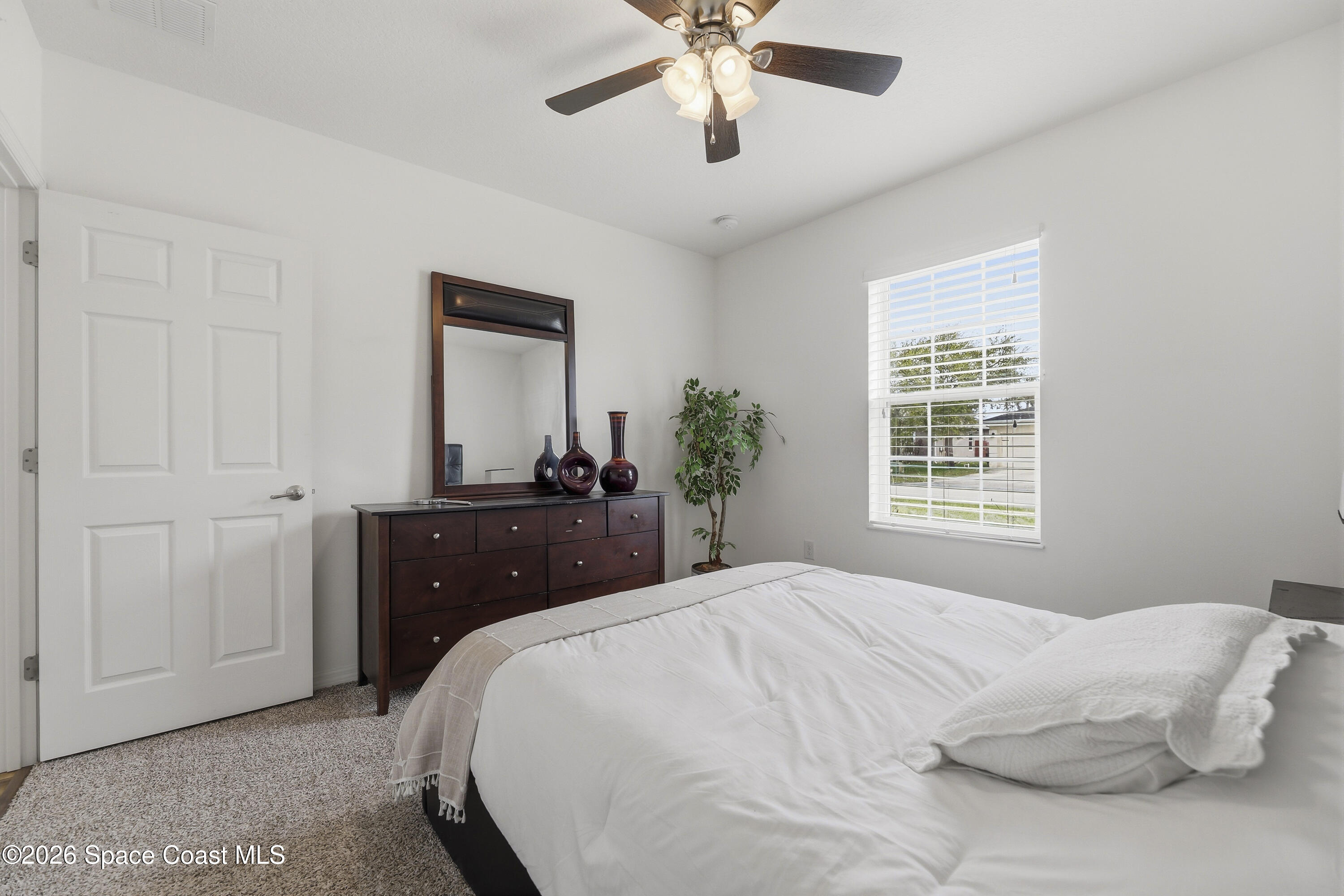 1121 Morgan Circle Northeast Palm Bay, FL 32905 - Photo 69 of 115 a bedroom with a bed and a mirror