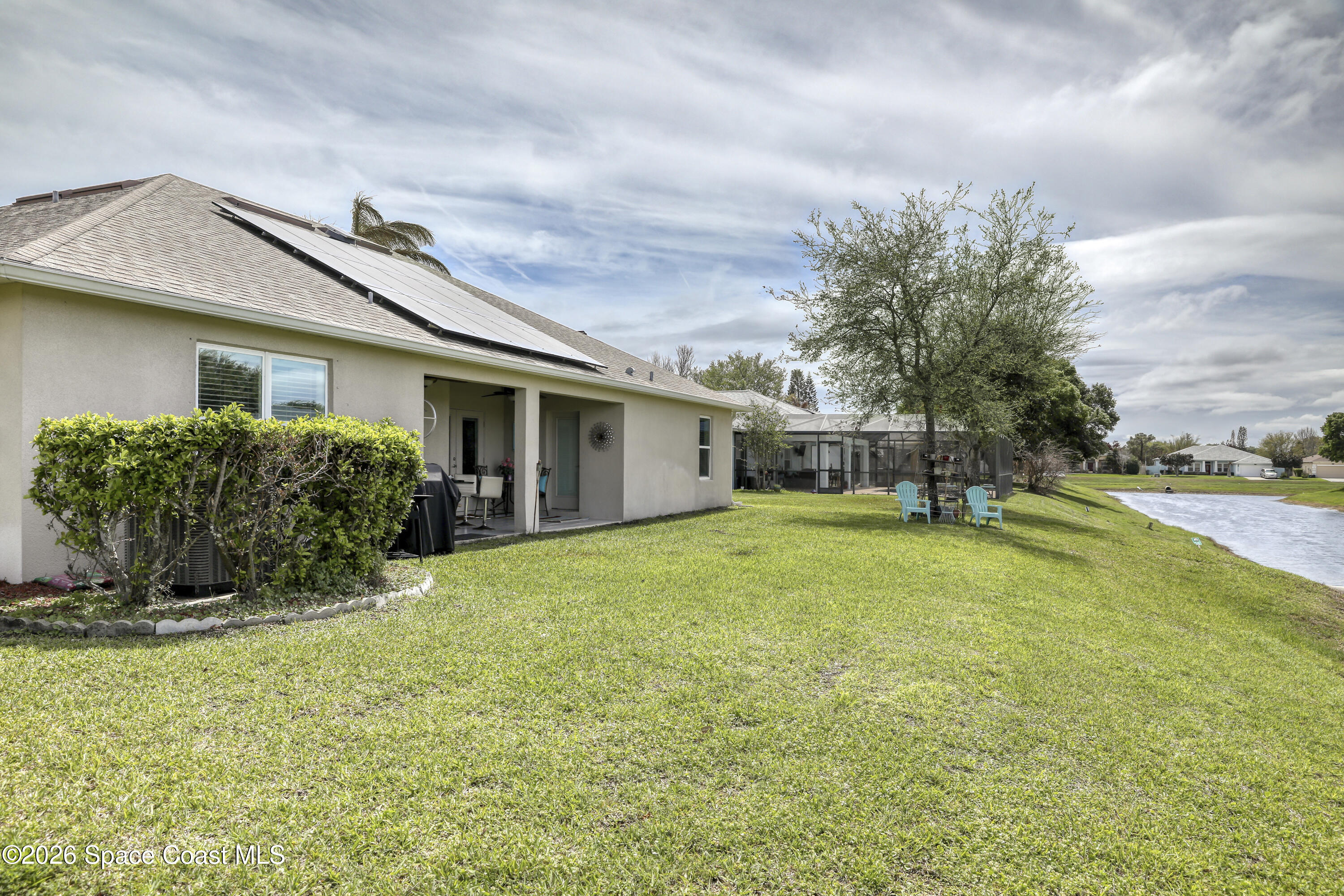 1121 Morgan Circle Northeast Palm Bay, FL 32905 - Photo 100 of 115 a front view of house with yard and trees in the background