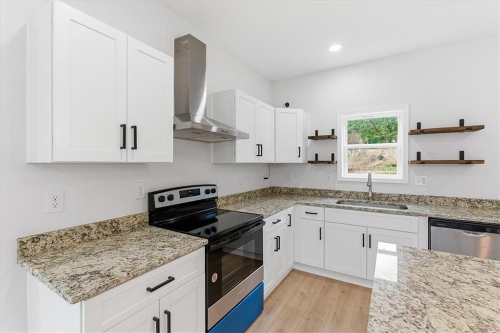 119 Jackson Street Cedartown, GA 30125 - Photo 15 of 58 a kitchen with stainless steel appliances granite countertop a sink stove and cabinets