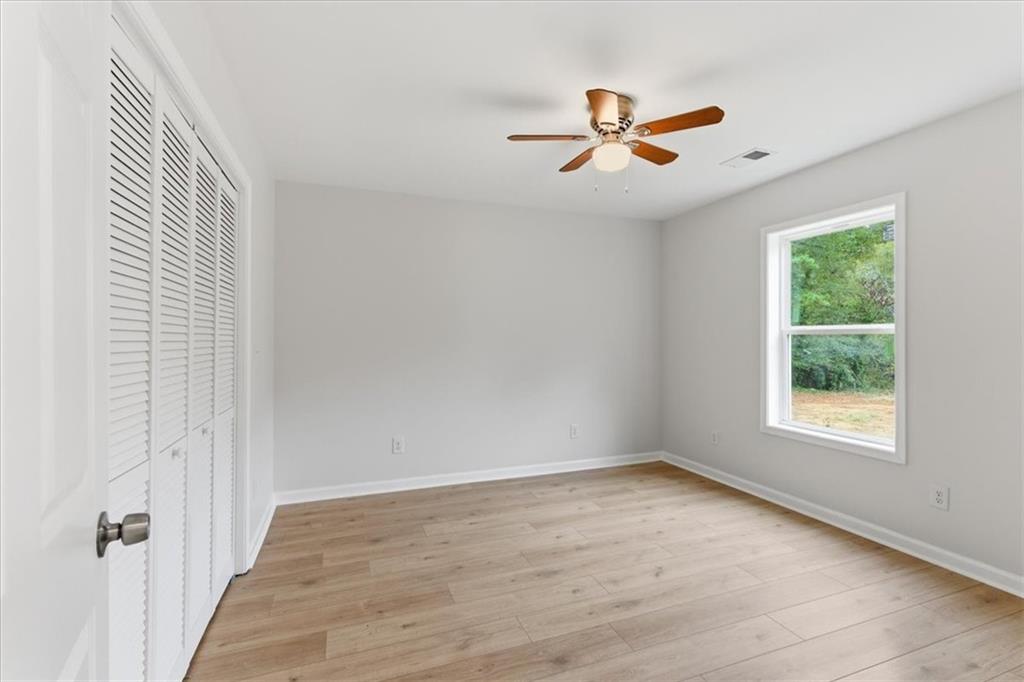 119 Jackson Street Cedartown, GA 30125 - Photo 28 of 58 wooden floor in an empty room with a window