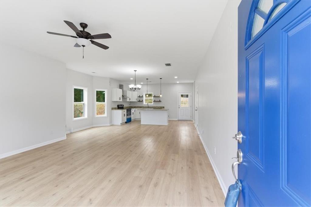 119 Jackson Street Cedartown, GA 30125 - Photo 4 of 58 a view of empty room with wooden floor and ceiling fan