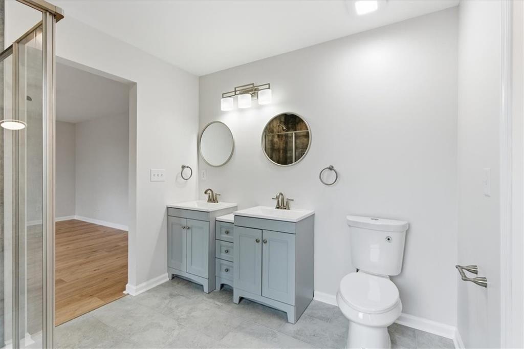 119 Jackson Street Cedartown, GA 30125 - Photo 43 of 58 a bathroom with a toilet a sink and mirror