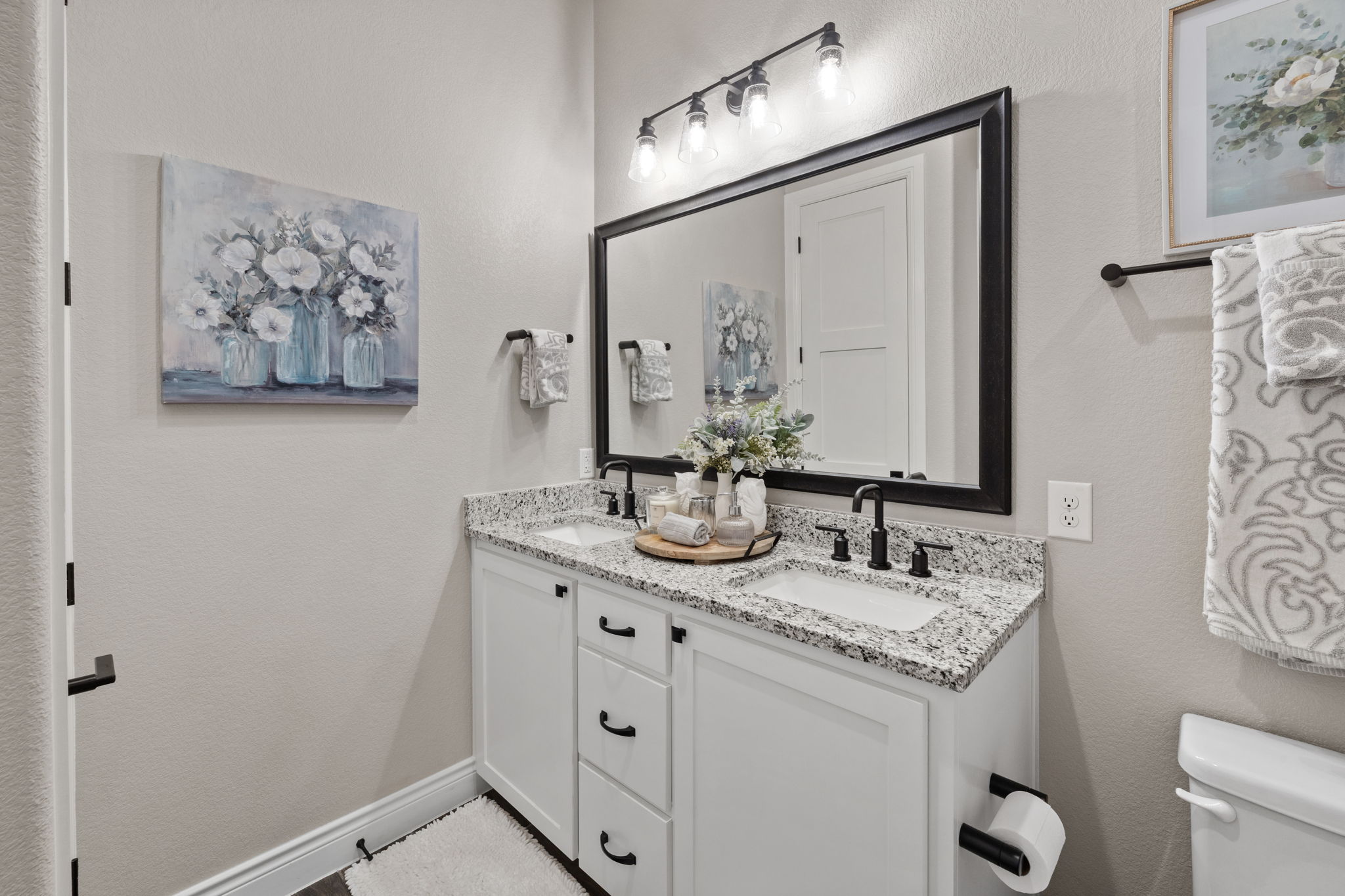 104 Lower Cedar Cove Georgetown, TX 78633 - Photo 22 of 37 a bathroom with a granite countertop sink a mirror and a toilet