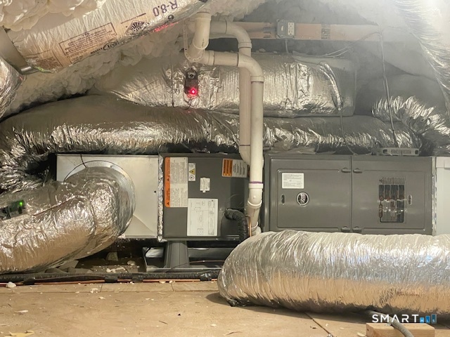 1 Cedar Road Danbury, CT 06811 - Photo 15 of 24 a bed sitting in a room next to a lamp