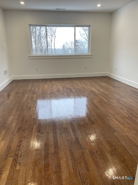 1 Cedar Road Danbury, CT 06811 - Photo 20 of 24 an empty room with wooden floor and windows